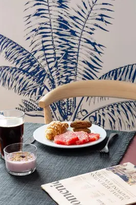 a plate of food and a drink on a table at Hotel Principe Di Villafranca in Palermo