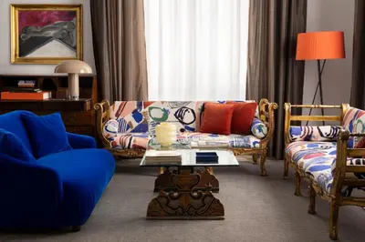 a living room with a couch and chairs and a table at Hotel Principe Di Villafranca in Palermo