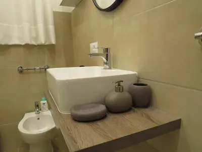a bathroom with a sink and a toilet at TRISOLE Palermo in Palermo