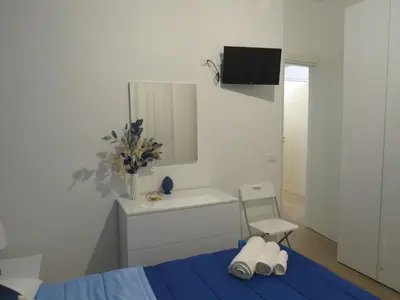 a bedroom with a bed and a sink and a mirror at TRISOLE Palermo in Palermo
