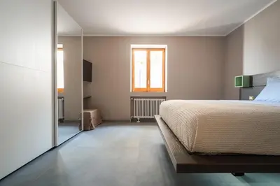 a bedroom with a large bed and a window at Villa vista mare con piscina riscaldata a Trappeto in Balestrate