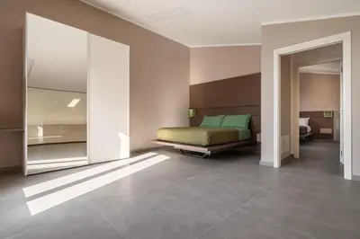 a bedroom with a bed in the middle of a room at Villa vista mare con piscina riscaldata a Trappeto in Balestrate