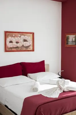a bed with white sheets and towels on it at PalerMonAmour Art Gallery Suite in Palermo