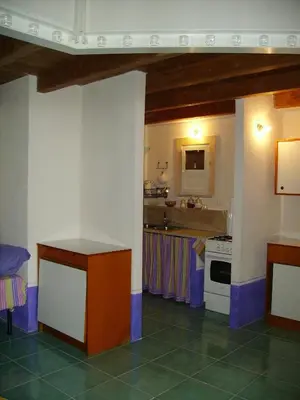 a bedroom with a bed in a room with wooden ceilings at I Macaseni di Franca in Scopello