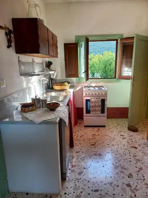 a small bedroom with a bed and a window at I Macaseni di Franca in Scopello