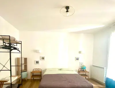 a bedroom with a bed and a ceiling fan at via pannieri apartament in Palermo