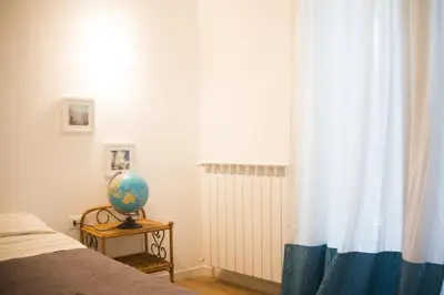 a bedroom with a bed and a window and a globe at via pannieri apartament in Palermo