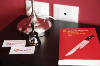 a table with a knife and a book on it at B&B Rodionoff Palermo View & Terrace Mondello-Airport Link in Palermo
