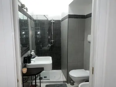 a small bathroom with a sink and a toilet at The traveler's house in Palermo