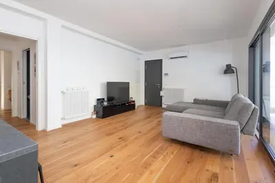a living room with a couch and a television at Mondello Addaura Addisio Suite in Palermo