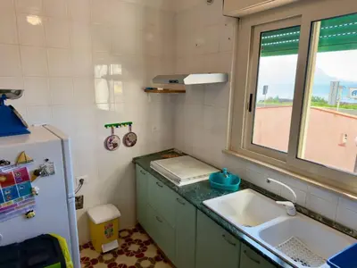 a small kitchen with a sink and a window at 100 passi dal mare in Isola delle Femmine