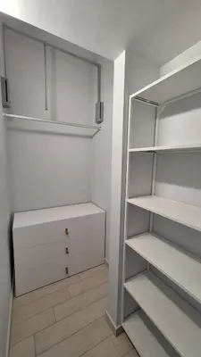 a white room with a refrigerator and a shelf at Casa XXI Aprile in Isola delle Femmine