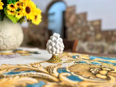 a small figurine on a table with a vase of flowers at Nonna Sasà in Torretta