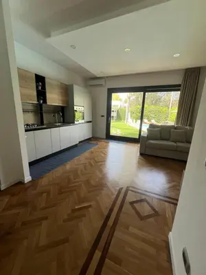 a large living room with a couch and a kitchen at Villa Losanna in Mondello