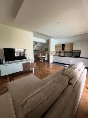 a living room with a couch and a television at Villa Losanna in Mondello