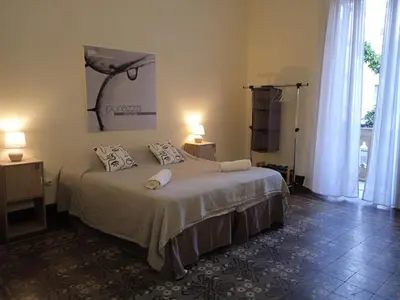 a bedroom with a bed with two pillows on it at Nowhere Rooms in Palermo