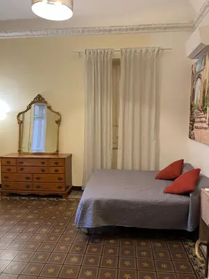 a bedroom with a bed and a mirror and a dresser at Nowhere Rooms in Palermo