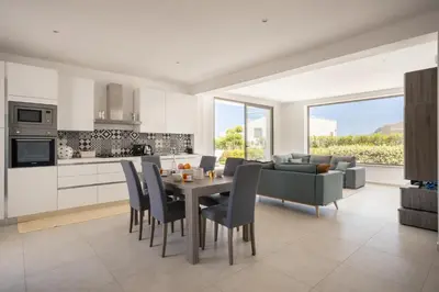 a kitchen and living room with a table and chairs at Grande Villa privata con piscina a Scopello in Castellammare del Golfo
