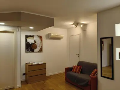 a living room with a chair and a mirror at Casabella Mondello in Mondello