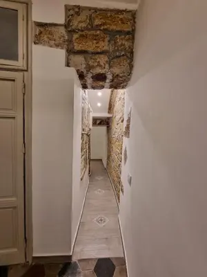 a hallway with a brick wall and a hallway with a corridorngthngthngthngth at Domus Sant'Anna Apartment in Palermo