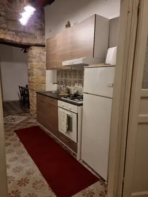 a kitchen with a white refrigerator and a stove at Domus Sant'Anna Apartment in Palermo