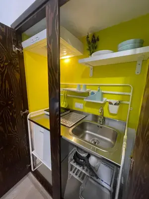 a small kitchen with a sink and yellow walls at Casa Vittoria in Palermo