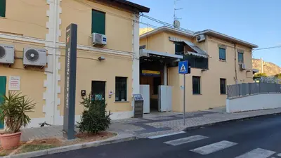 a street with two buildings and a street sign on the side at Casa Zibè in Isola delle Femmine
