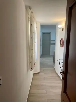 a kitchen with a sink and wooden cabinets at Maqueda Apartament for 4 Palermo Centre Ballarò in Palermo