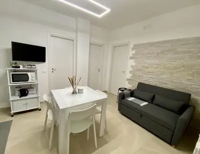 a living room with a couch and a table at Katy's Holiday House, Private Villa and Pool in Terrasini