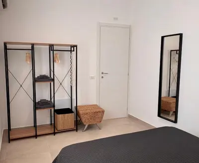a bedroom with a bed and a mirror at Katy's Holiday House, Private Villa and Pool in Terrasini