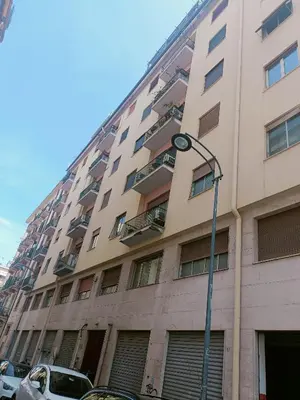 a tall building with a street light in front of it at onoratocinque house apartment in Palermo