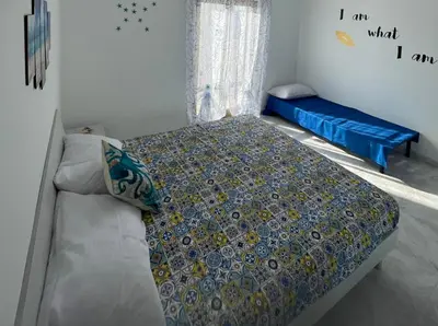 a bedroom with a bed and a couch at Casa Scirocco in Balestrate