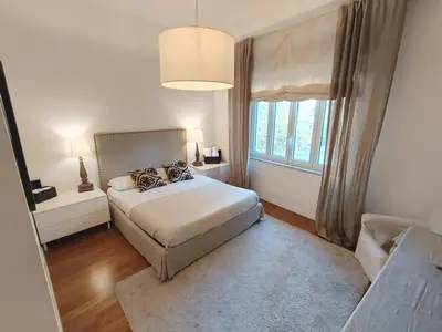 a bedroom with a bed and a large window at Palermo Eleganza in centro città in Palermo