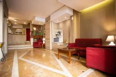 a living room with a red couch and a table at Hotel Posta in Palermo