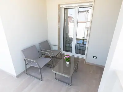 two chairs and a table in a room with a window at Alta Marea Sea Apartments in Balestrate