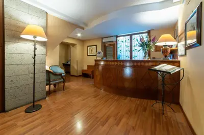 a hotel lobby with a reception desk and a waiting room at Massimo Plaza Hotel in Palermo