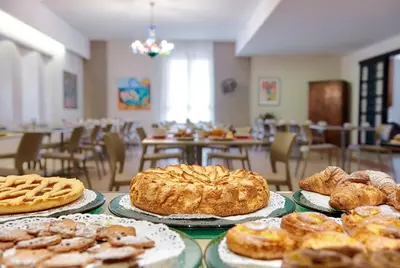 a table topped with different types of pastries and pies at Hotel Al Madarig in Castellammare del Golfo