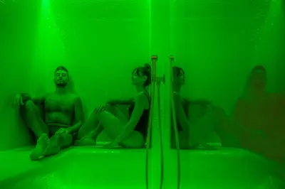 a group of people sitting in front of a green room at Hotel Al Madarig in Castellammare del Golfo