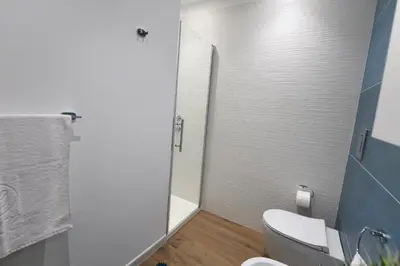 a bathroom with a toilet and a shower with a mirror at Terra Sinus Luxury apartment in Terrasini