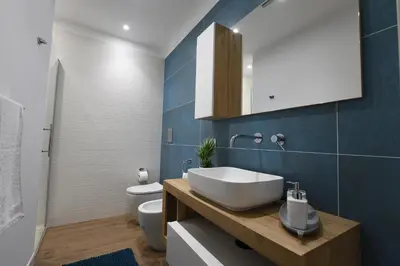 a bathroom with a sink and a toilet at Terra Sinus Luxury apartment in Terrasini