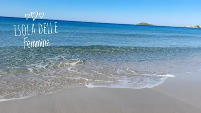 a beach with the ocean and the words koala delle feminism at Casa il Bergamotto in Palermo