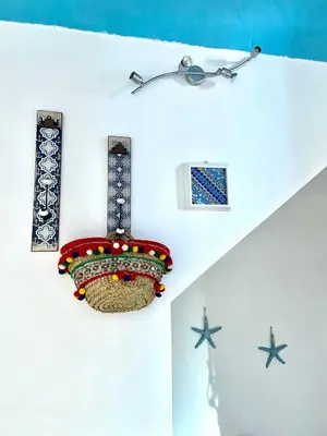 a room with a chandelier and stars on the wall at Casa vacanze stella marina in Trappeto