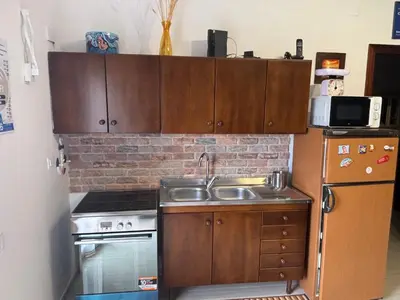 a kitchen with a sink and a stove and a refrigerator at Casa Maria Costa Blu in Isola delle Femmine