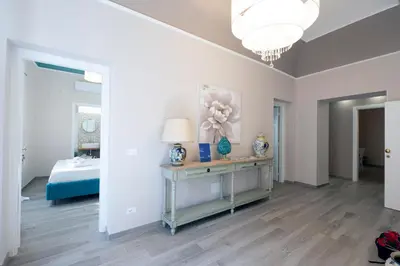 a bedroom with a bed and a table with a lamp at Domus Federiciana in Castellammare del Golfo