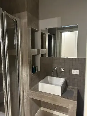 a bathroom with a white sink and a shower at Malusi B&B in Sferracavallo