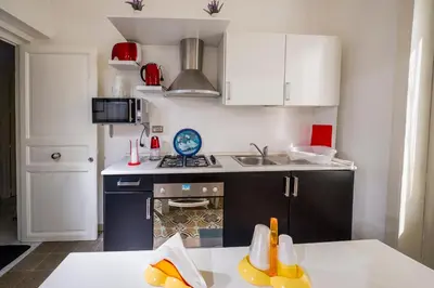 a kitchen with a sink and a stove top oven at Le Case di Katy in Castellammare del Golfo