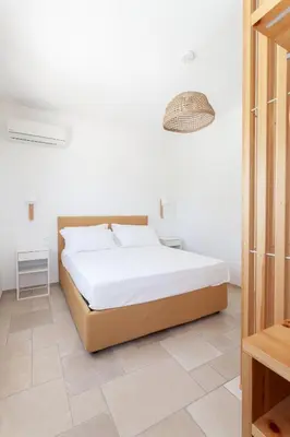 a bedroom with a large bed in a room at Zizha Suite sul mare - San Vito Lo Capo in San Vito lo Capo