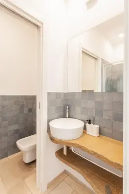 a bathroom with a sink and a toilet at Zizha Suite sul mare - San Vito Lo Capo in San Vito lo Capo