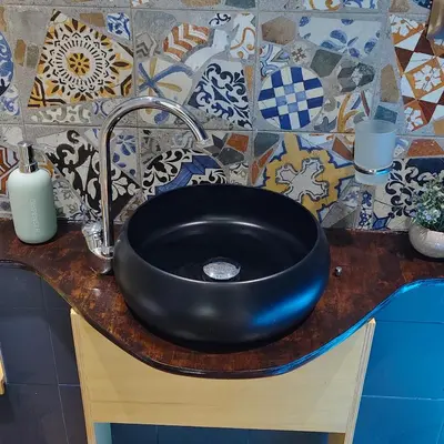 a black sink on a counter in a bathroom at Studio Sedie Volanti in Palermo