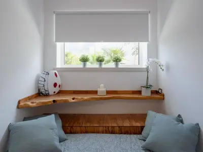 a window with a wooden bench under a window shade at Holiday Home Quirat by Interhome in Terrasini